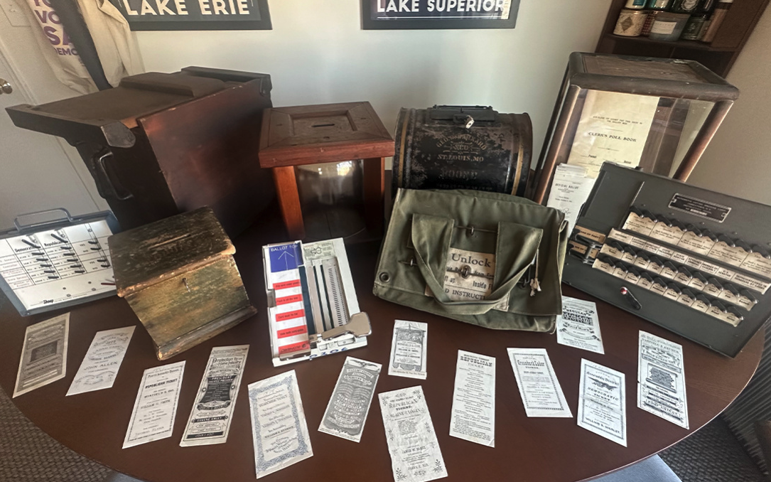 Myers' collection of vintage voting ballots, boxes, and other accessories.